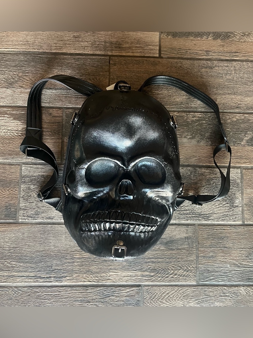 Hard formed skull shaped backpack with skull print lining black